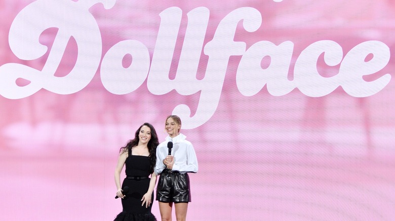 Kat Dennings with Margot Robbie in front of a Dollface sign