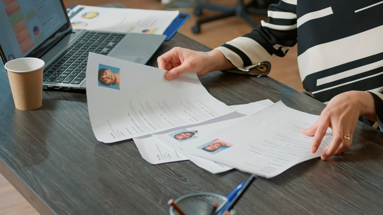 A person looking at resumes