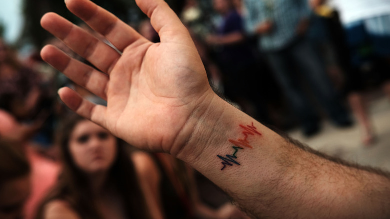 tattoo of a pulse on someone's wrist