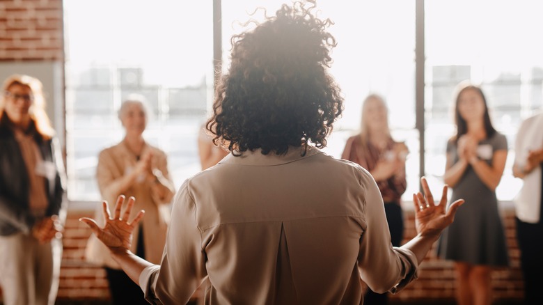 Woman giving speech to coworkers