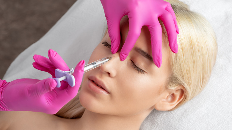 Woman getting injection in nose