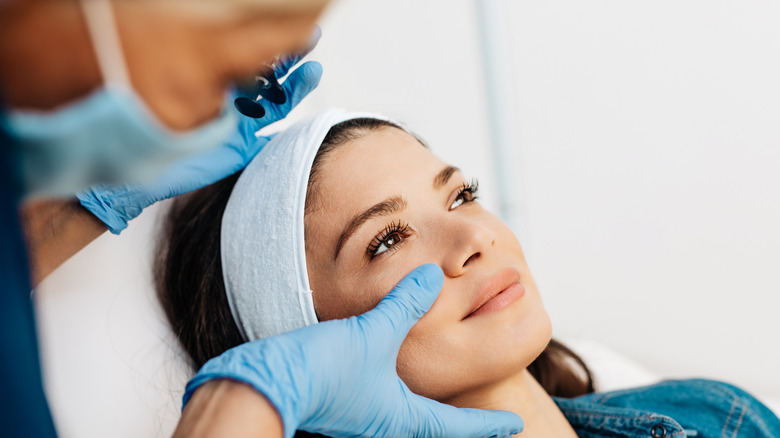 Woman having face assessed