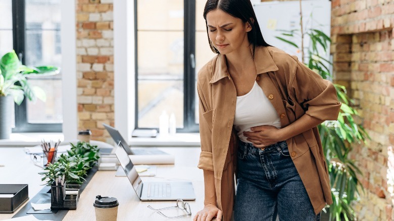 Woman with cramps at work