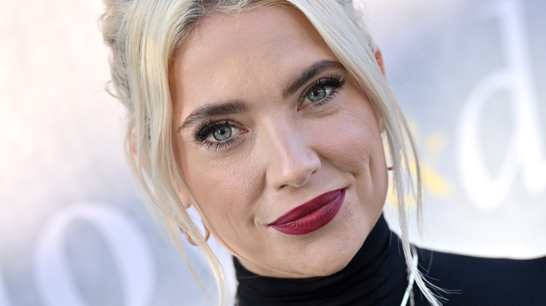 Ashley Benson smiles at a red carpet event