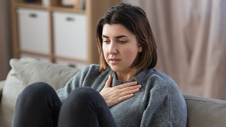 woman holding chest