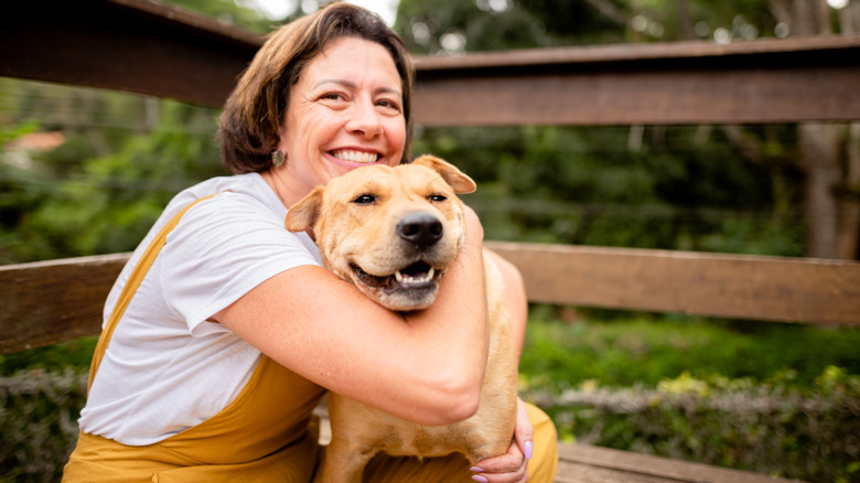 woman cuddling her dog