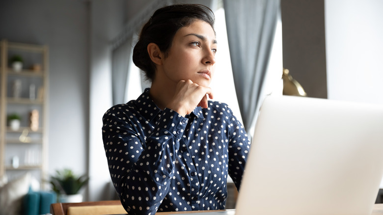 Woman looking out window