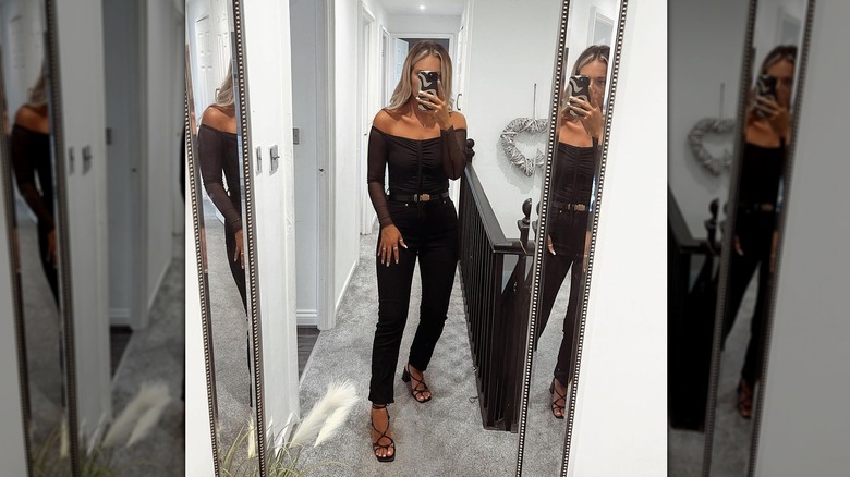 Wearing all-black outfit