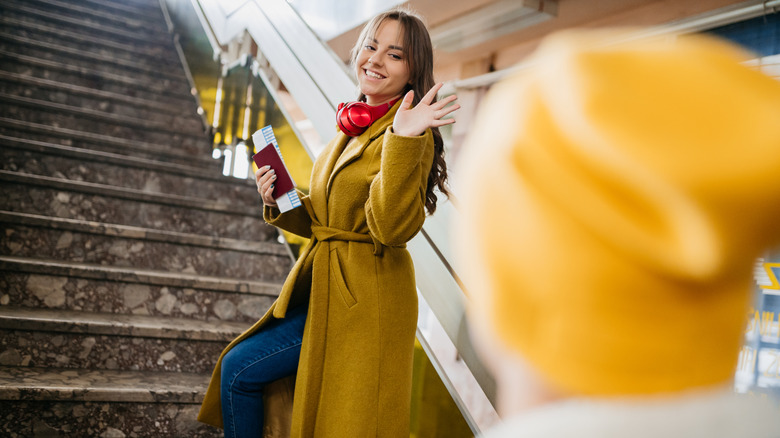 woman waving goodbye 