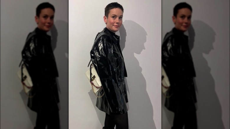 Brie Larson on Instagram with a pixie cut, wearing a leather jacket