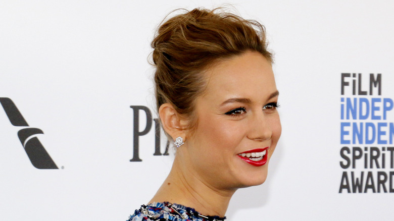 Brie Larson on the red carpet with her hair up in a messy bun