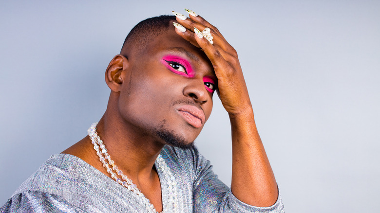 Gender fluid person with bright eyeshadow