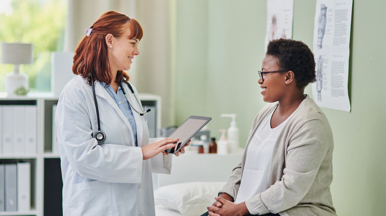 Woman speaking to a doctor