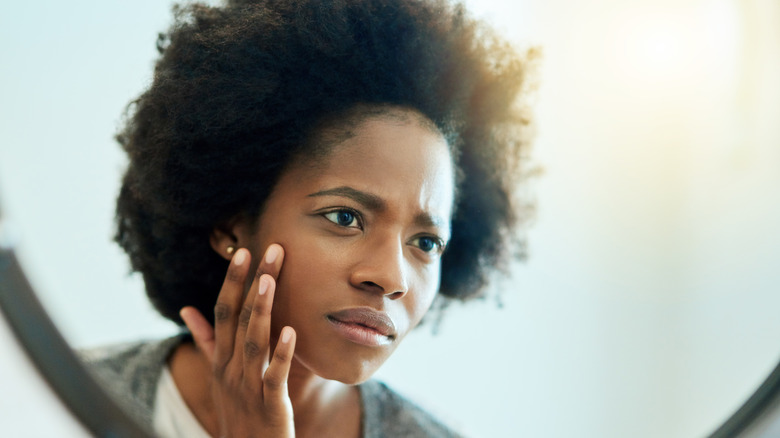 Woman touching her face