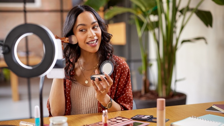 Woman applying makeup