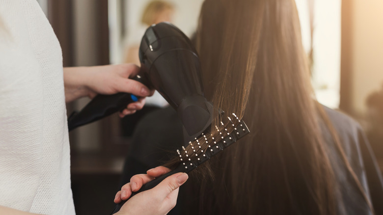 Woman blow-drying her hair