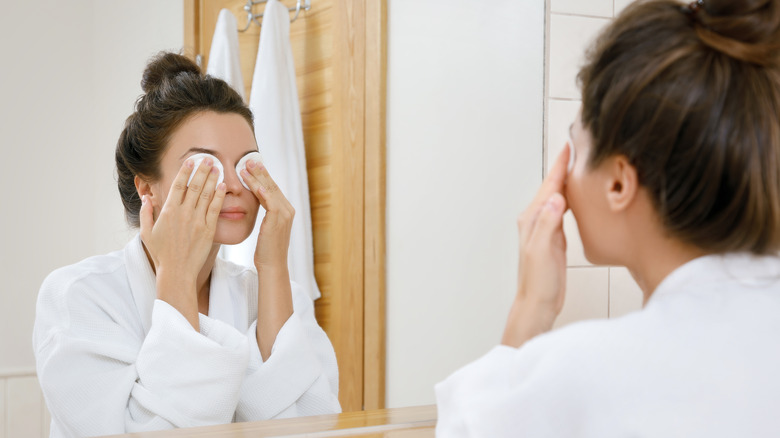 Cotton pads over eyes