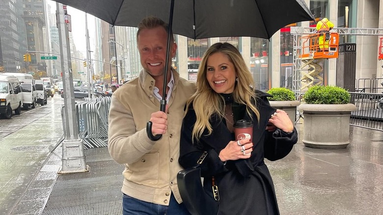 Valeri Bure and Candace Cameron Bure under an umbrella