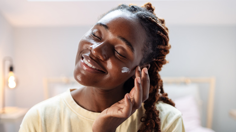 Woman applying skincare