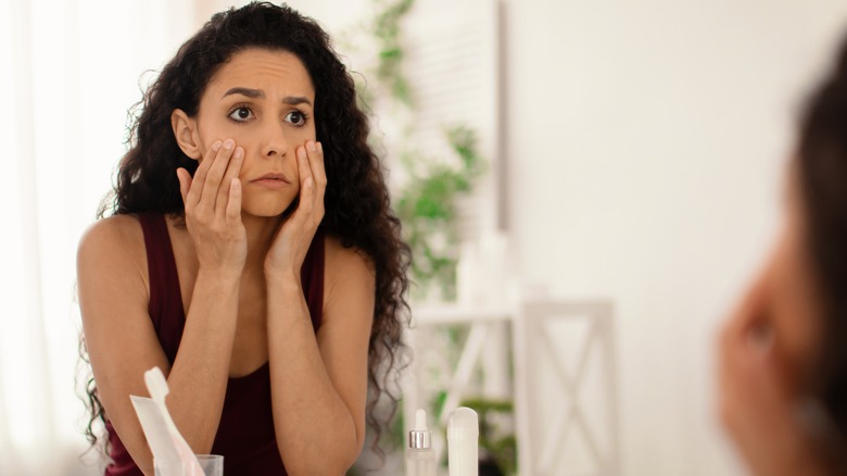 Woman looking at skin