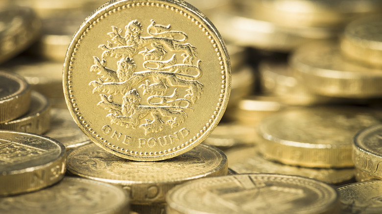 a pile of British one pound coins