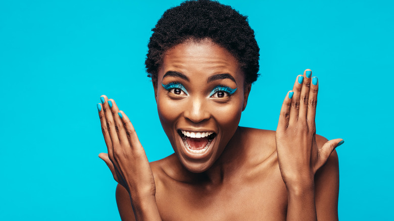 Woman wearing bright blue eyeshadow