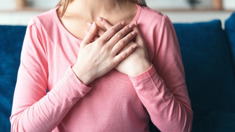 Woman with hands over heart