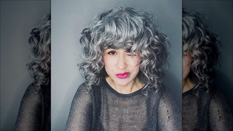 Woman with curly bangs