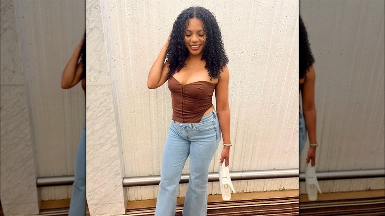 Woman with curly curtain bangs