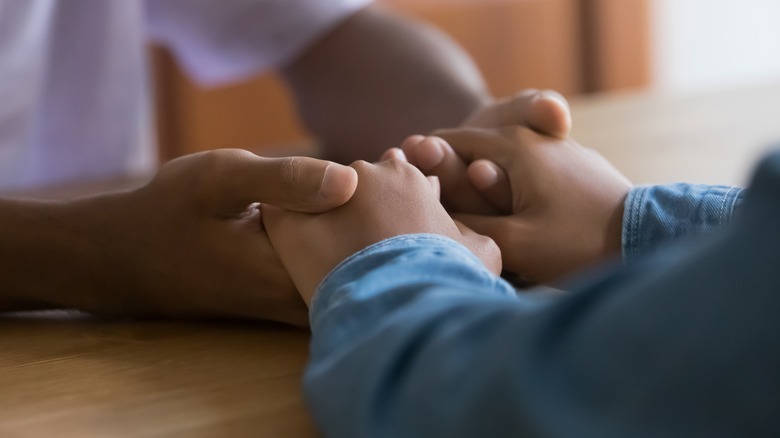 two people holding hands