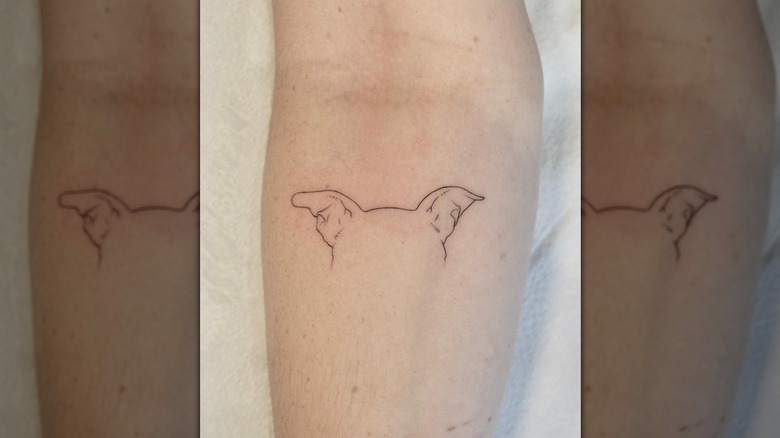 Dog ear line tattoo