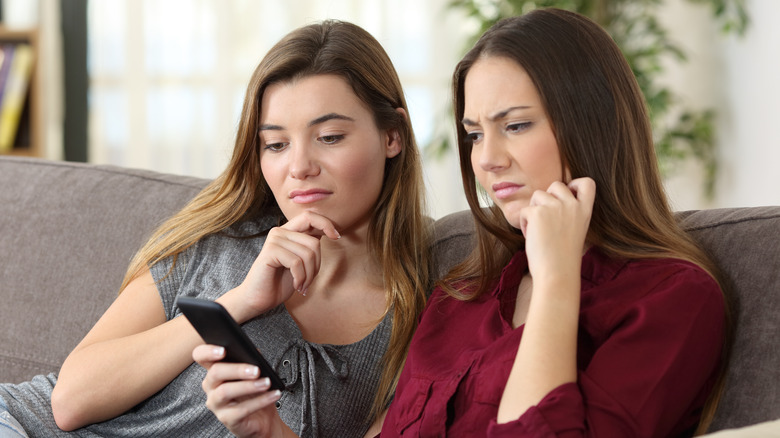 two women looking at phone