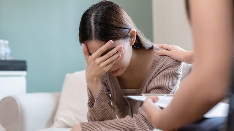 Woman with her head in her hand