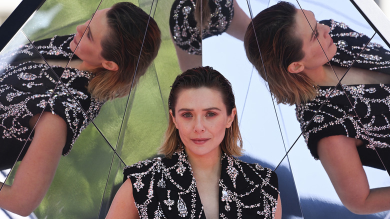 Elizabeth Olsen photographed in front of a reflective background