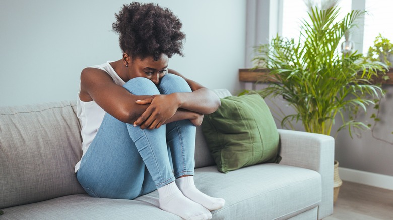 Woman sitting isolated on couch