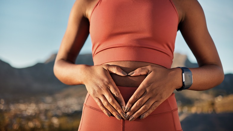 woman touching abdomen