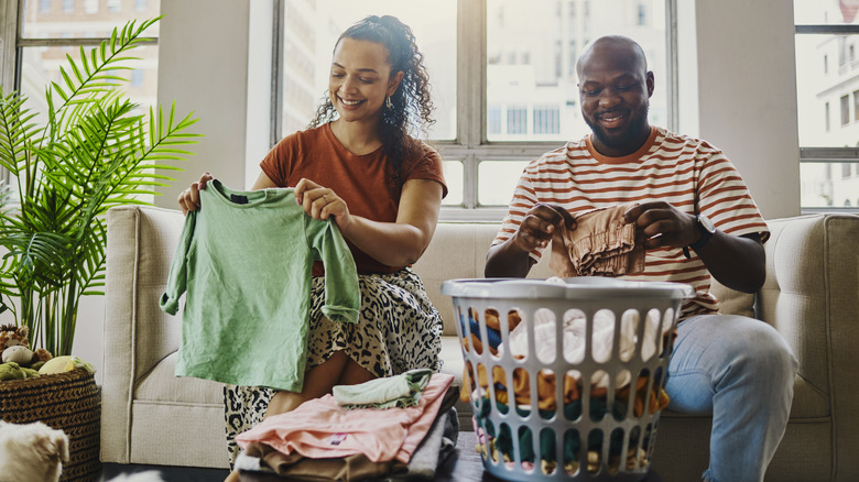 Couple folding laundry together