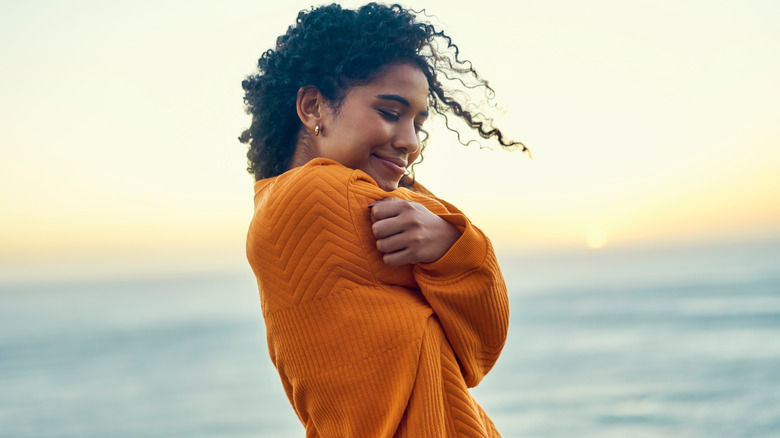 Woman hugging herself
