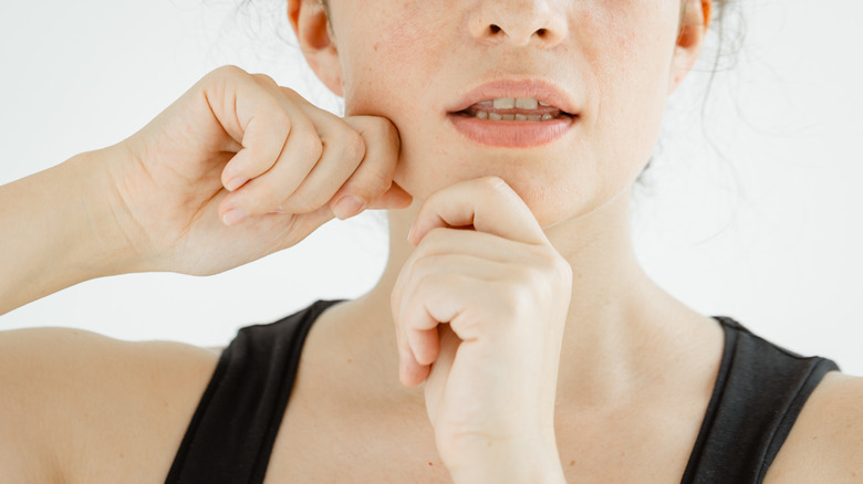 Woman performing facial exercises
