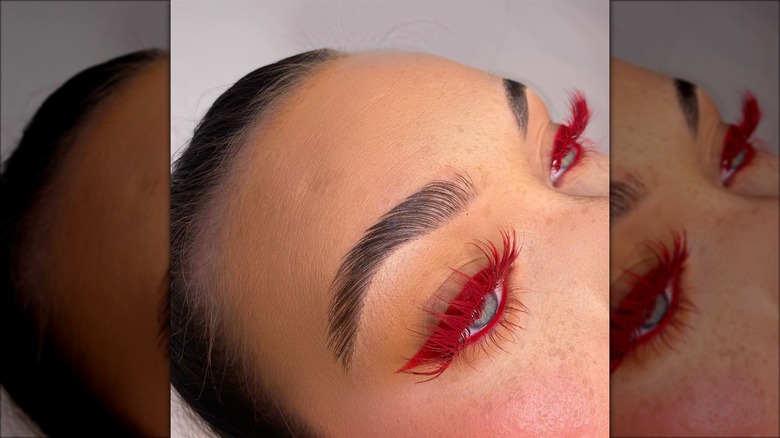Woman wearing red false eylashes