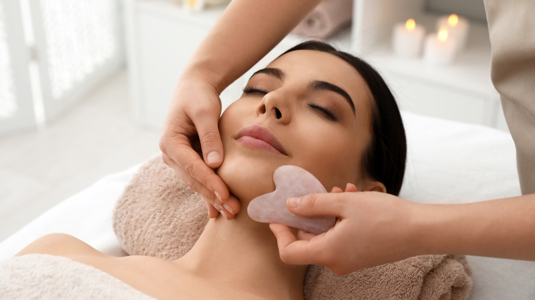 Woman receiving gua sha treatment