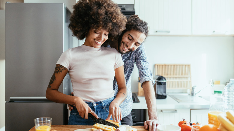 couple making charcuterie board