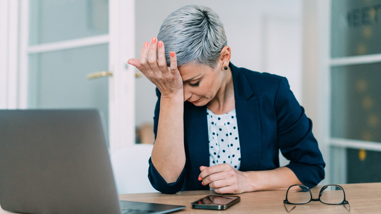Woman looking stressed at work
