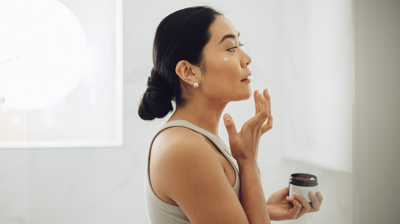 Woman applying skincare