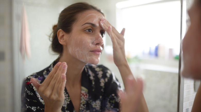 Woman applying skincare