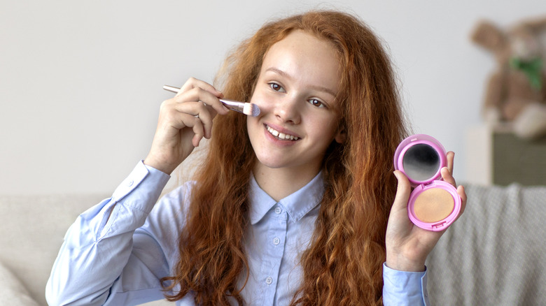 Woman applying makeup