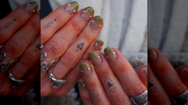 A woman with short, green nails on Instagram