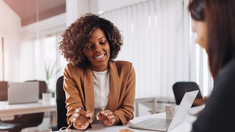 woman in interview explaining numbers