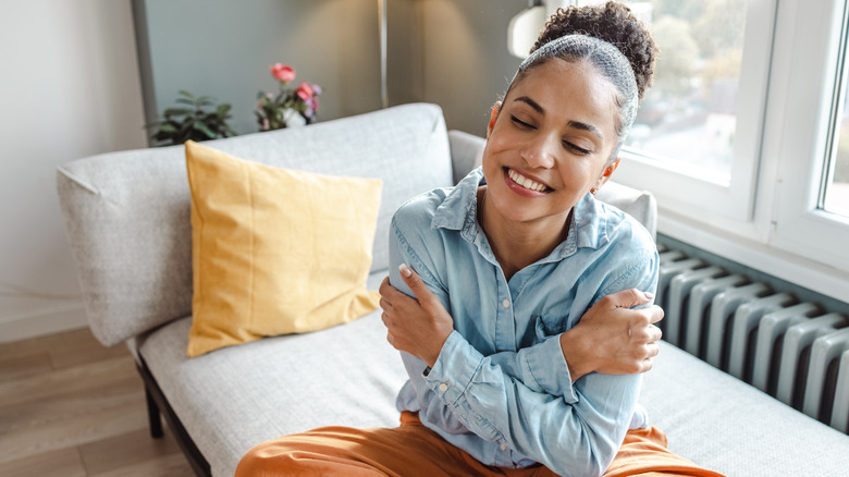 Woman hugging herself