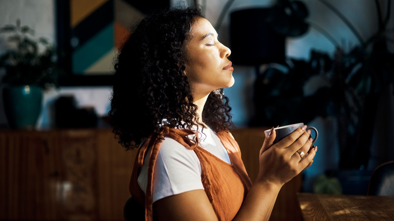 Holding mug in sunlight